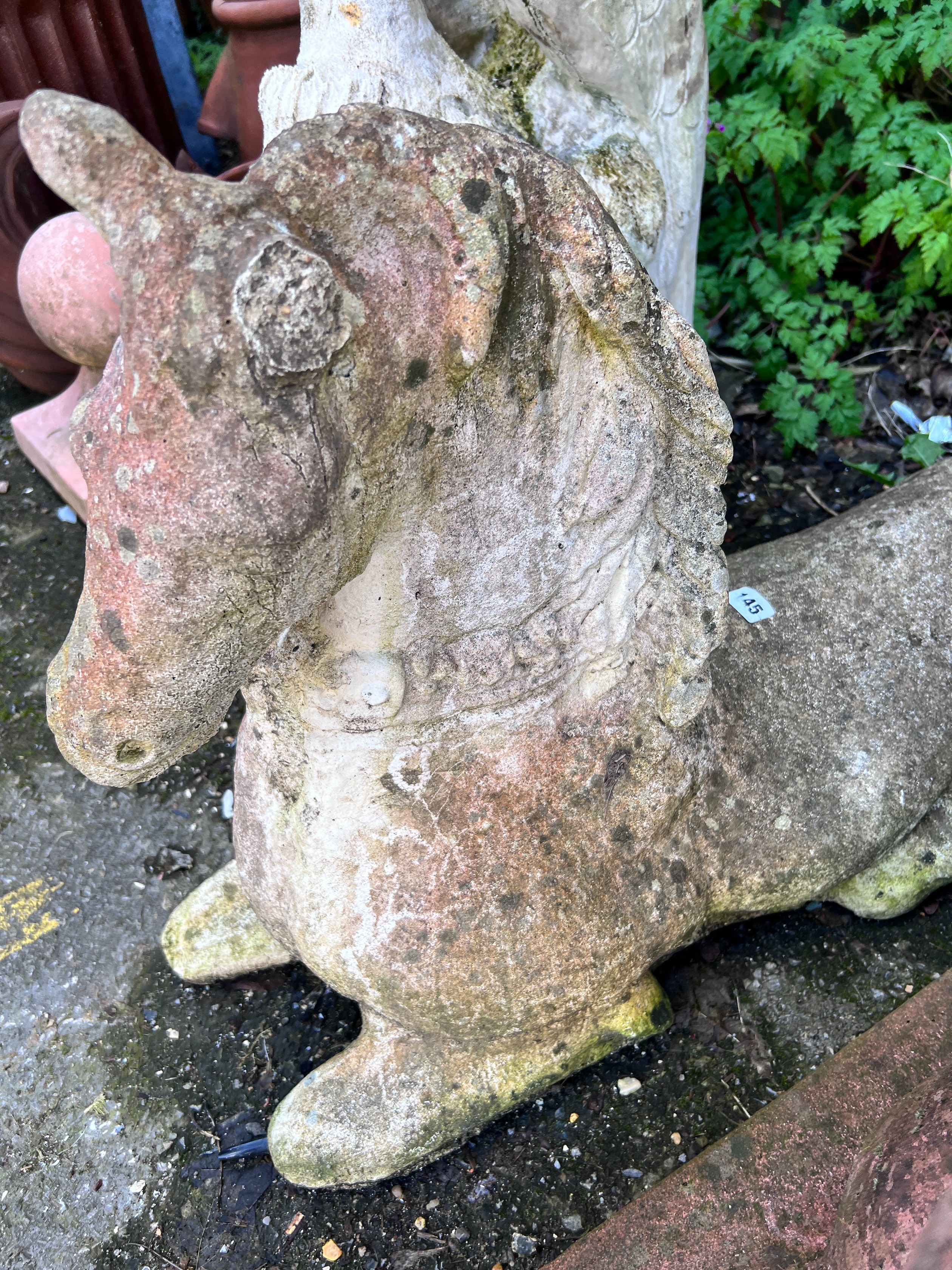A reconstituted stone recumbent horse, height 55cm *Please note the sale commences at 9am.